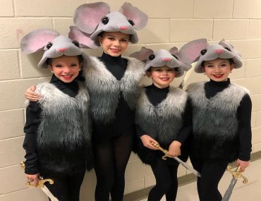 Four girls posing and smiling